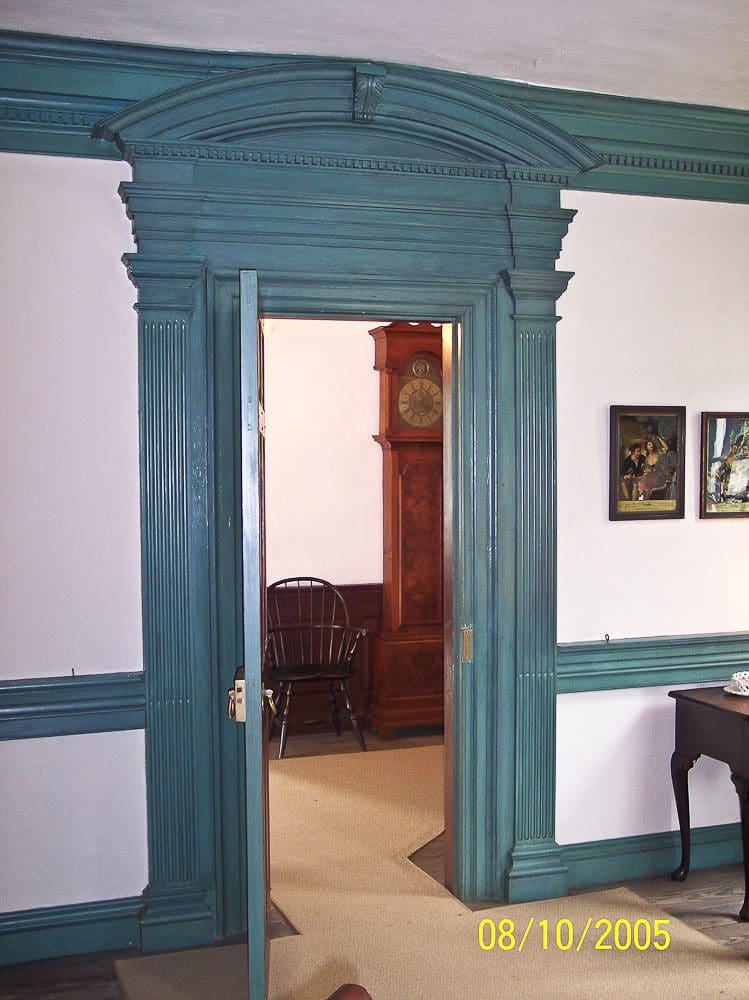 A room with a blue door and white walls.