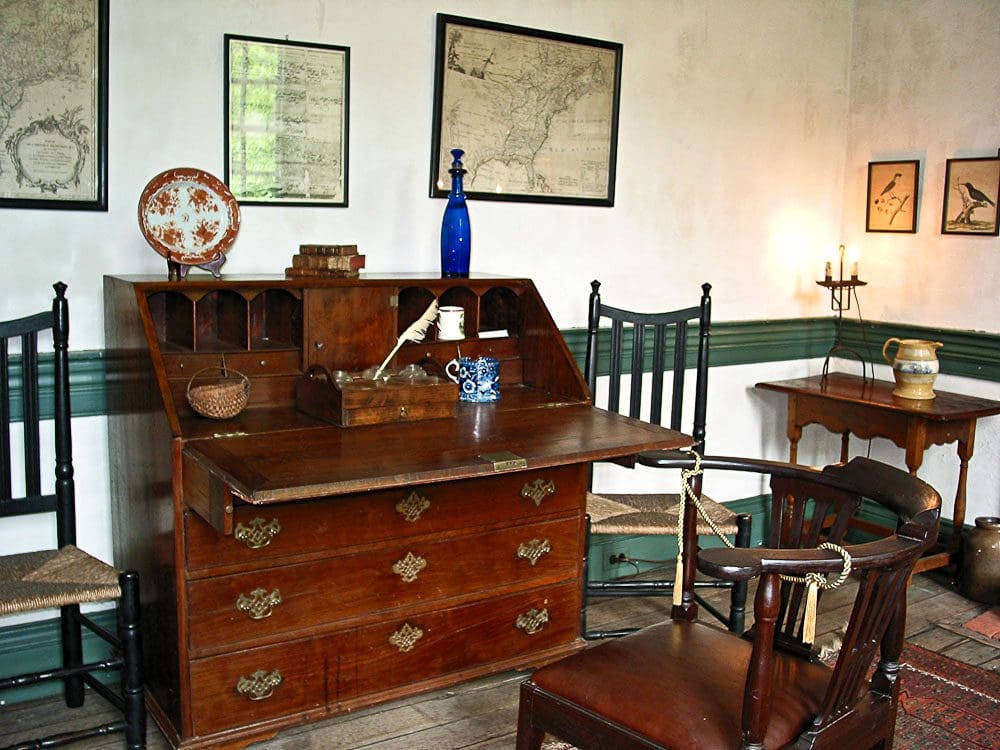 A room with furniture and a map on the wall.