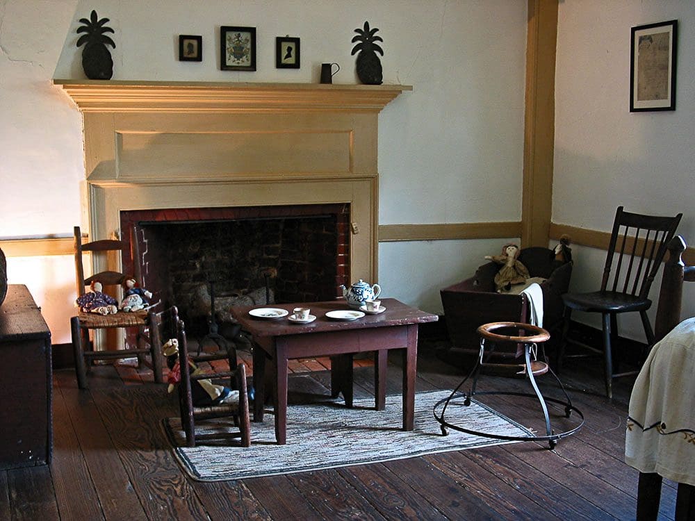 A room with a fireplace and wooden floors