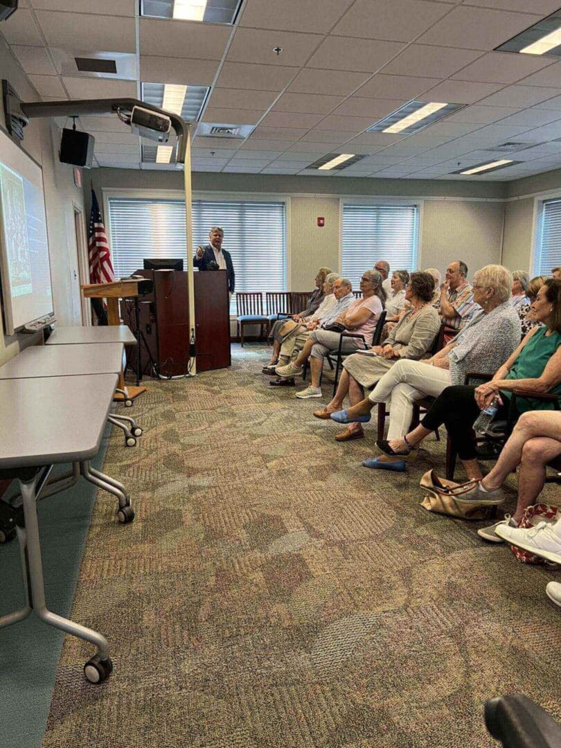 Speaker presenting to seated audience.
