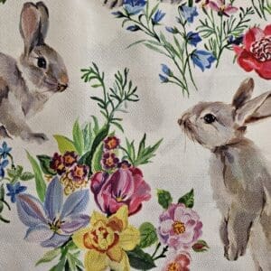 Rabbits surrounded by colorful flowers.