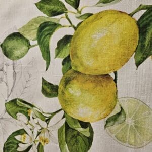 Lemon illustration on fabric with green leaves.
